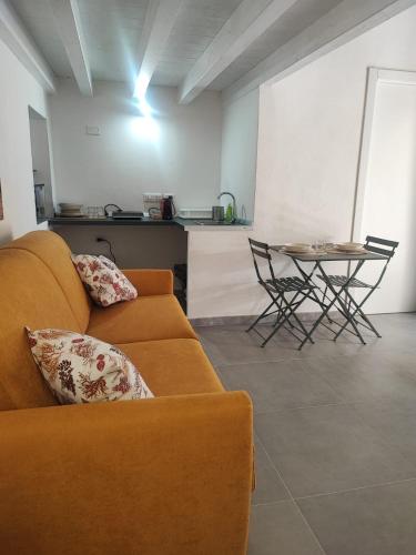 a living room with a couch and a table at Monolocale Zena in Carloforte