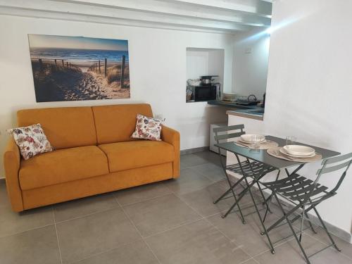a living room with a couch and a table at Monolocale Zena in Carloforte