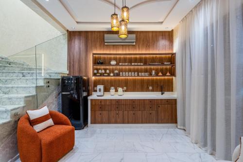 a bathroom with an orange chair and a sink at Villa Lina in Marrakech