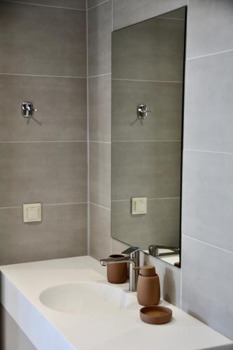 a bathroom with a sink and a mirror at LIViT Condo Elafonisi in Agios Padeleimon