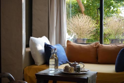 a living room with a couch with pillows and a table at Dechiu in Hoi An
