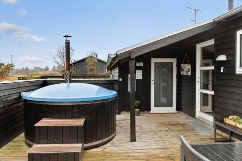 a hot tub on the deck of a house at 1322-Snedsted-Lykkens-Hab-21 in Snedsted