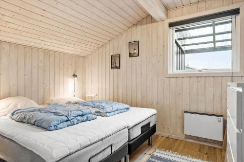 a bedroom with a bed in a room with a window at 1322-Snedsted-Lykkens-Hab-21 in Snedsted