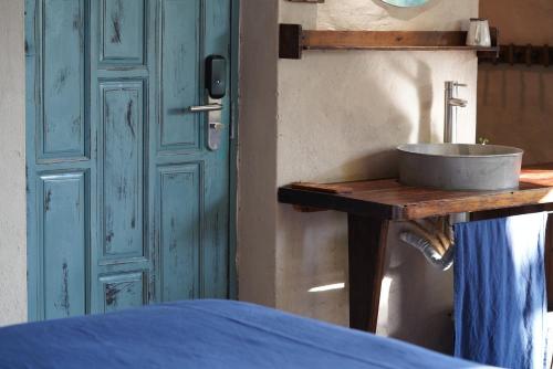 a sink on a wooden table next to a door at Dechiu in Hoi An