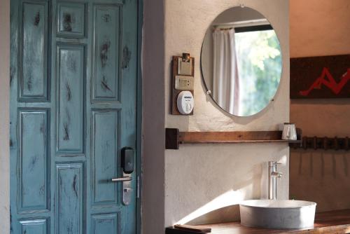 a bathroom with a blue door and a sink at Dechiu in Hoi An