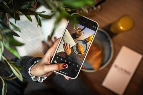a woman holding a cell phone in her hand at Royal National Hotel in London
