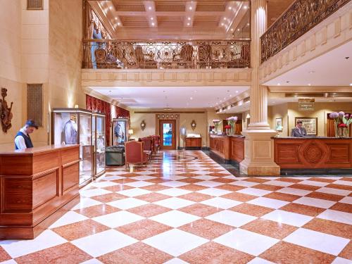a large lobby with a checkerboard floor at Grand Hotel Wien in Vienna