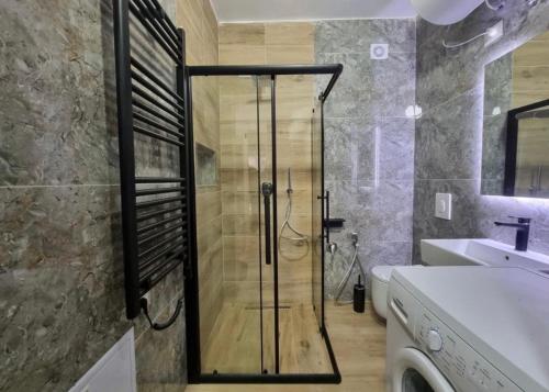 a shower with a glass door in a bathroom at dorian beach appartment 4 in Durrës