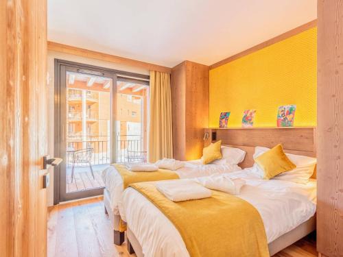 a bedroom with two beds and a window at Appart chic avec SPA, parking et WIFI - Les Arcs 1800 - FR-1-352-96 in Arc 1800
