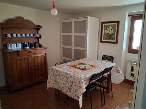 a dining room with a table and chairs and a table and a window at 643km landa etxea in Villatuerta