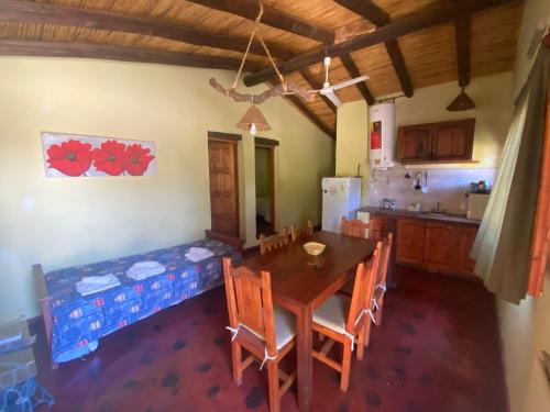 a kitchen and dining room with a table and chairs at cabañas las viñas in Anguinán