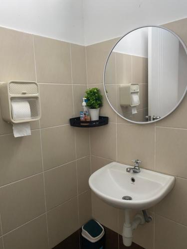 a bathroom with a sink and a mirror at Single storey bungalow Tangkak in Tangkak