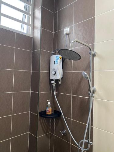 a shower with a shower head in a bathroom at Single storey bungalow Tangkak in Tangkak