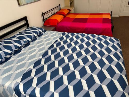 two beds sitting next to each other in a bedroom at Room in New York in Jackson Heights