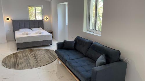a living room with a couch and a bed at Palma Village by Greek Pride Hotels in Skála Foúrkas