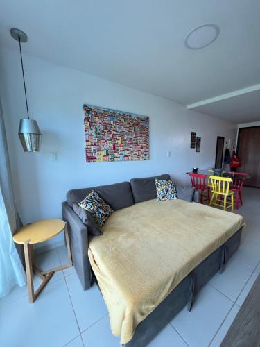 a bed in a living room with a couch at Porto Plaza Flat Service Apt 309 in Porto De Galinhas