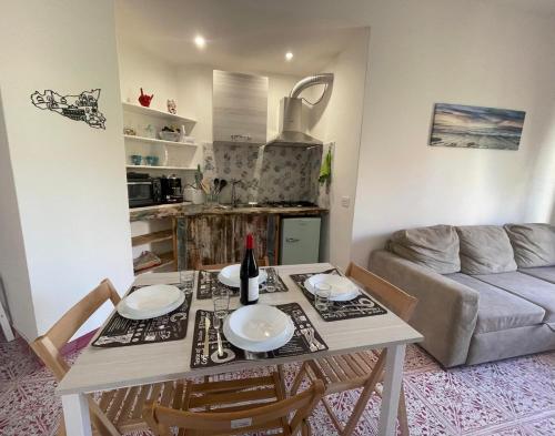 a kitchen and living room with a table and chairs at Adele Garden in Taormina
