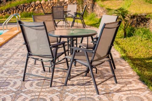 a group of chairs and a table with a glass top at THE LAGOON RESORT AND Spa in Kutu