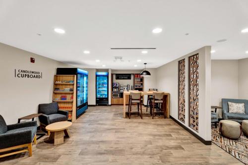 a waiting room with chairs and a table at Candlewood Suites - Detroit - Auburn Hills by IHG in Auburn Hills