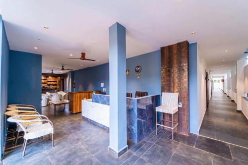 a lobby with blue walls and a table and chairs at Rococo mandrem beach resort in Old Goa