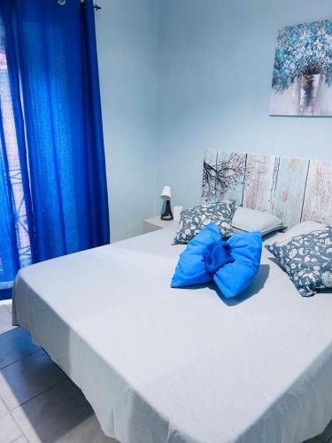 a large bed with blue pillows on top of it at Le Costarelle Sabine in Torri in Sabina