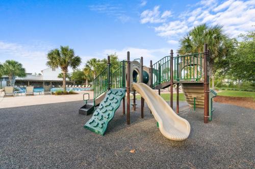a playground with a slide in a park at Beach House - Redfish Cove at Windmark Beach by Panhandle Getaways in Port Saint Joe
