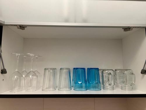 a row of glass vases sitting on a shelf at Zen Suite in Novi Beograd