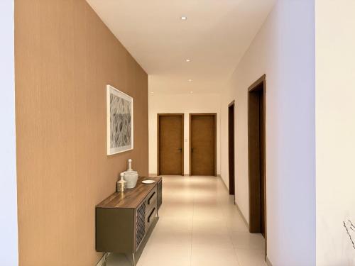 a hallway with a dresser in the middle of a room at R&R Homes in Kwedonu