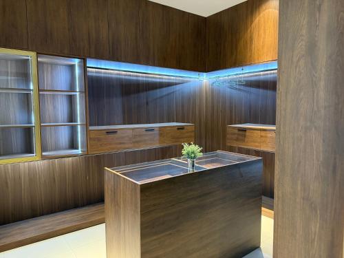 a bathroom with wooden walls and a bath tub at R&R Homes in Kwedonu