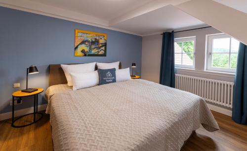 a bedroom with a large bed and a window at Wohnpark Hotel Heppenheim in Heppenheim an der Bergstrasse