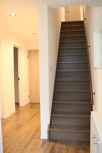 a staircase in a house with grey stairs at 空月の庵 in Osaka