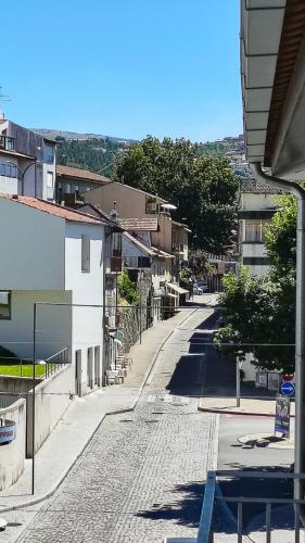 an empty street in a city with buildings at Bee Invitee - Alojamento Local in Amarante