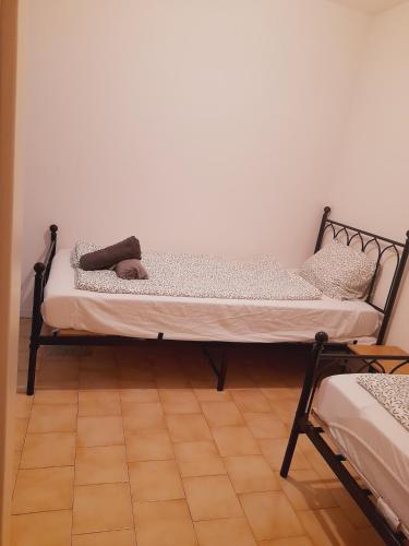 a bed sitting in a room with a floor at Aura Smart Haus con terrazza in Melano