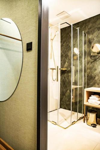 a bathroom with a shower and a mirror at Villa Gran in Esztergom