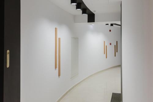 a hallway with white walls and art on the wall at City Center Accommodation - 410 in Reşiţa