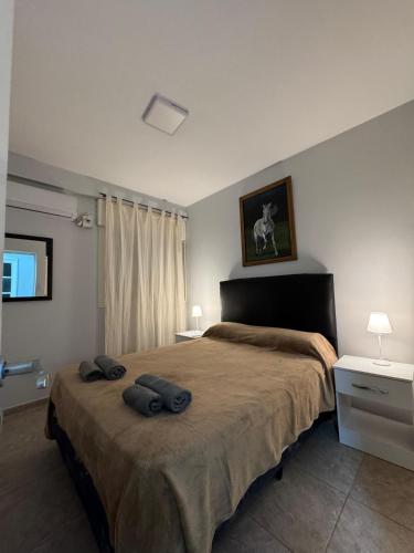 a bedroom with a large bed with two towels on it at Departamento Turistico Liro in Santa Lucía