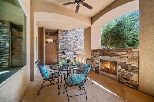 a dining room with a table and chairs and a fireplace at Pool & Sunshine Retreat - Resort-style Amenities in Hurricane