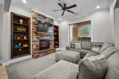 a living room with a couch and a fireplace at Pool & Sunshine Retreat - Resort-style Amenities in Hurricane
