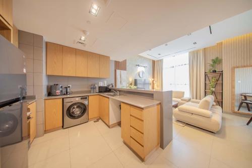 a kitchen with a washer and dryer in a room at 2BHK Family Apartment in Al Mamsha, Sharjah in Sharjah