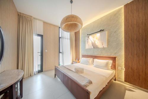a bedroom with a bed and a large window at 2BHK Family Apartment in Al Mamsha, Sharjah in Sharjah