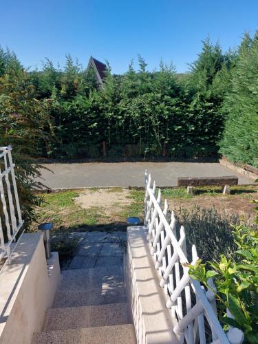 a white fence in a yard with a bench at GITE de THOMAS in Sarlande