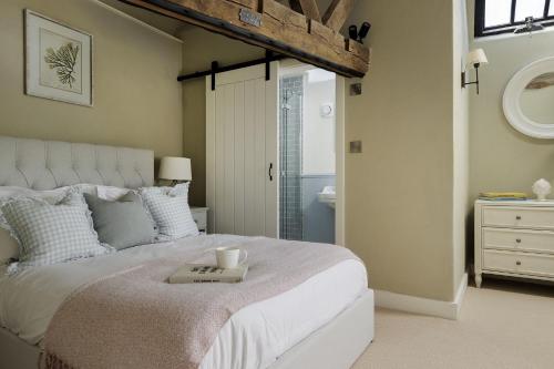 a bedroom with a bed with a tray on it at Flat 2 Martins House in Stow on the Wold