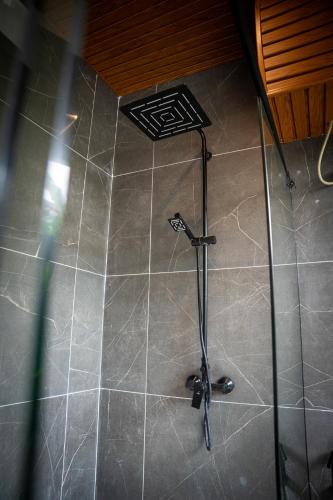 a shower in a bathroom with a tile floor at Emerald Villas by Paje Emerald Escapes Ltd in Paje