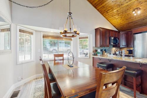 a kitchen with a wooden table and a dining room at Lakeview Lookout in Skyforest