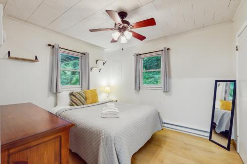 a bedroom with a bed and a ceiling fan at Bamboozled in Boone