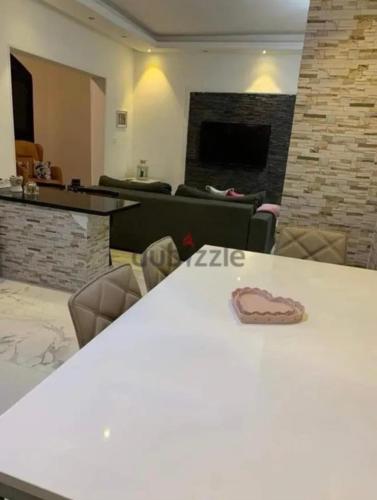 a room with a table and chairs and a fireplace at Dar Hadla in 6th Of October