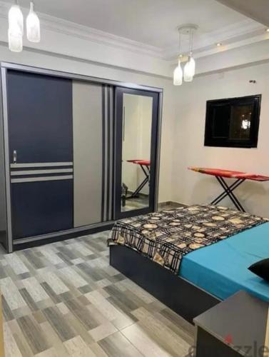 a bedroom with a bed and a sliding glass door at Dar Hadla in 6th Of October