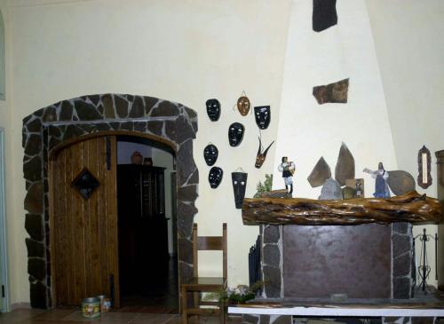 a room with a stone fireplace with decorations on the wall at Il Nuraghe del lago Coghinas in Oschiri