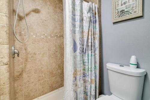 a bathroom with a shower curtain and a toilet at 4 Mi to Beach Home with Pool and Golf in Port Isabel! in Port Isabel