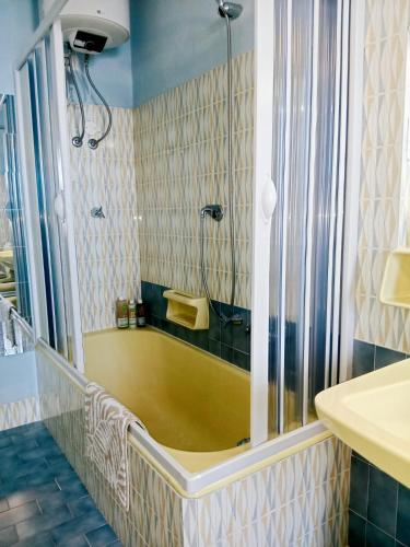 a bathroom with a tub with a shower and a sink at Sagittarius B&B in Cetraro